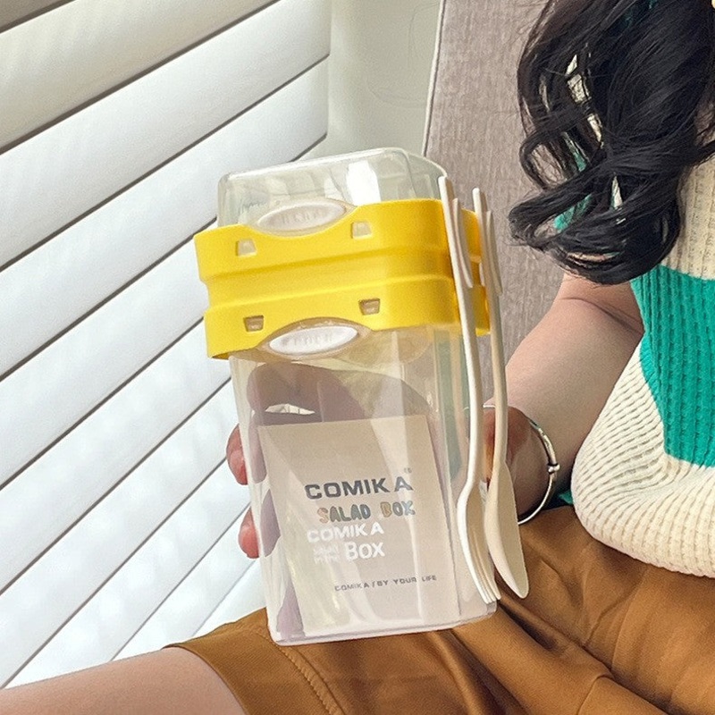 Yellow Portable salad cup with ingredient compartment and fork and spoon – enjoy breakfast on the go